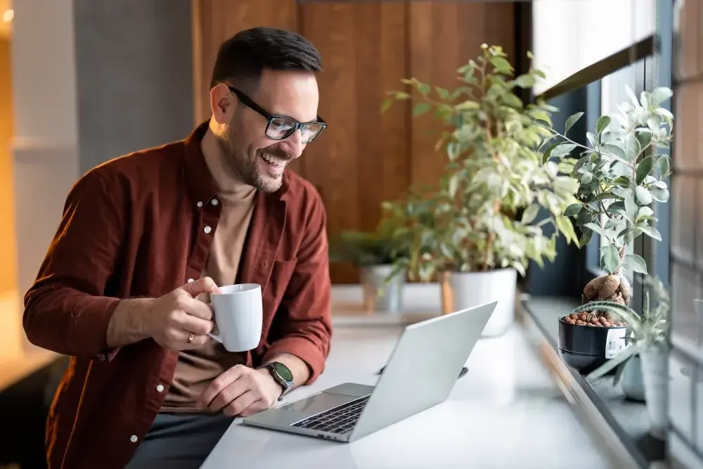 Before you start your business, it's best to see if the name is already being used. This man is checking online as he has a cup of coffee. Businesses can trademark their names nationwide if they register the name with the U.S. Patent and Trademark Office (USPTO).