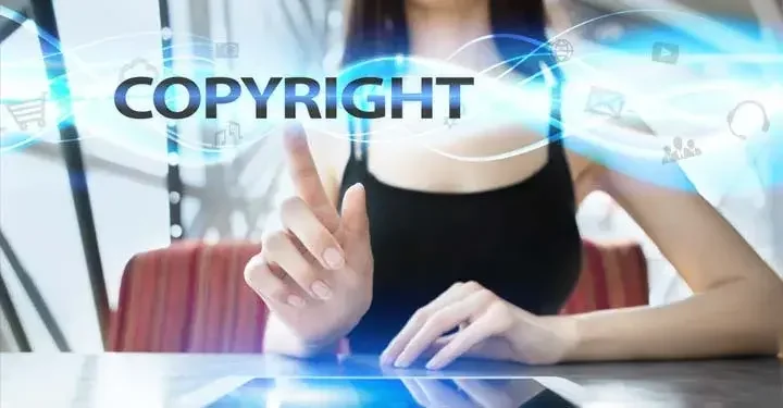 Woman pointing to text that reads "copyright"