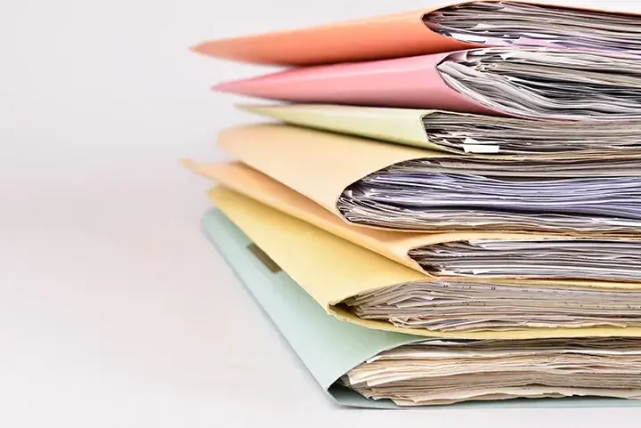 stack of file folders with paperwork inside 