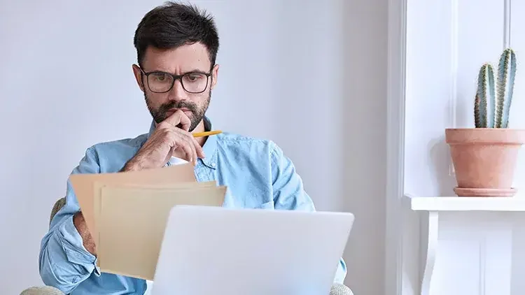 Man concentrating looks at documents