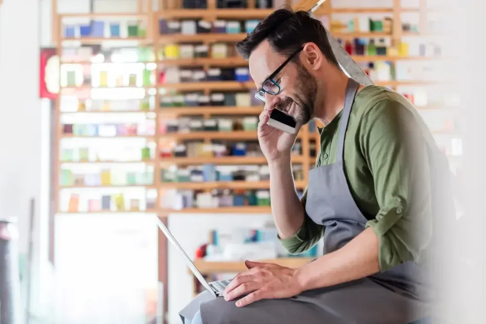 A small business owner sitting on a counter in his shop discusses forming an LLC in Illinois. 