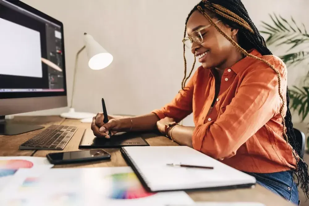 A woman decides to form a business as an LLC or inc. online while seated at her desk.