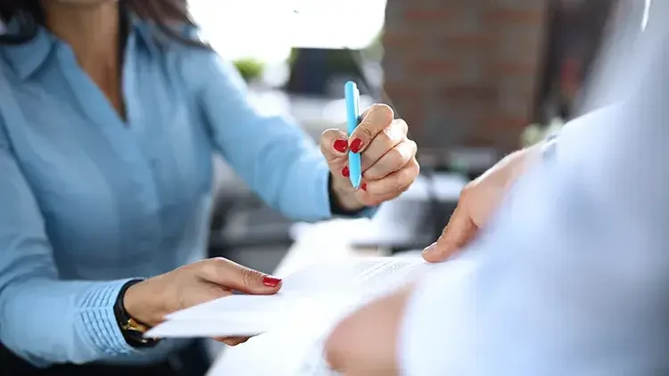 Woman and man signing documents