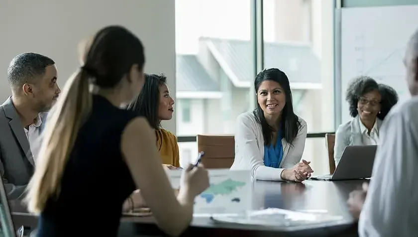 corporate-resolutions people sitting in a conference room in business attire