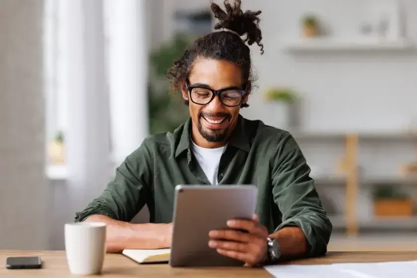 A man checks his bracket for capital gains tax. Capital gains tax is applied by the state and/or federal government when you sell an appreciated capital asset. 