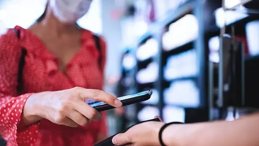 woman-scanning-phone-in-store-wearing-mask