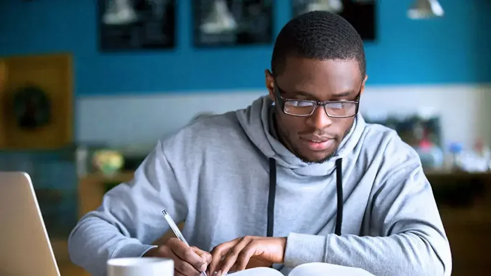 A student takes notes while seated at a table in his university's library. If you're not sure you need power of attorney, consider the factors listed in this article.