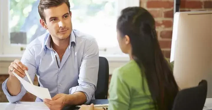 Sales rep and small business owner reviewing a document