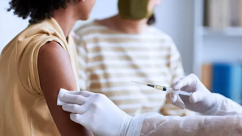 child-getting-vaccine with parent at dr office 