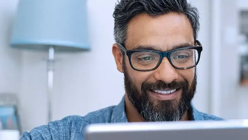 Man smiling looking at laptop