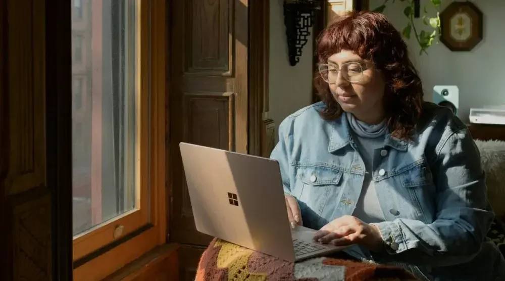 A business owner conducts a Massachusetts business search on her laptop.