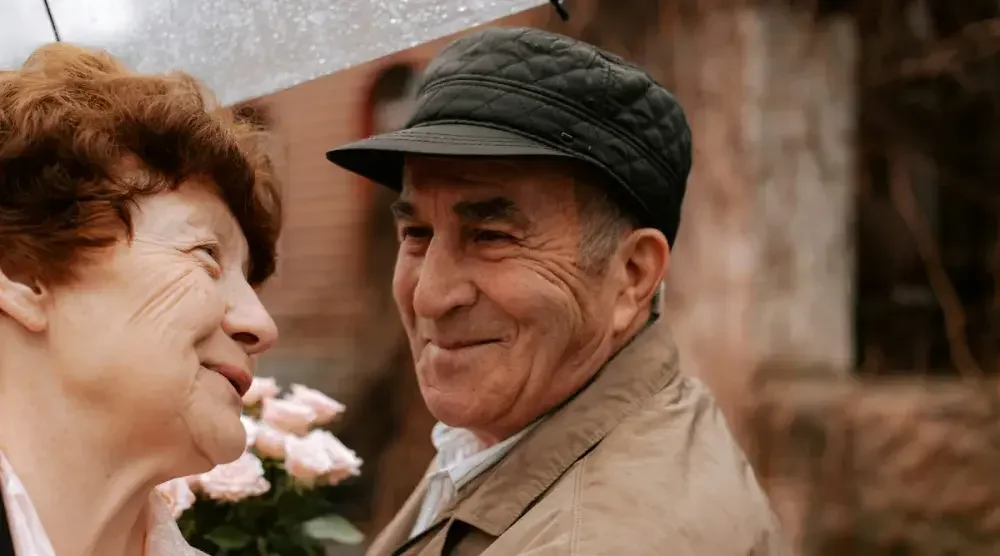 Woman looks at man with cap on outside. Common law marriage is not legally recognized in the state of New York.