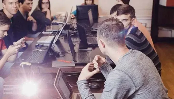 Business meeting where people are in front of their laptops and talking