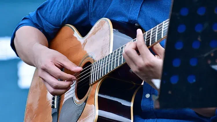 Man strumming guitar