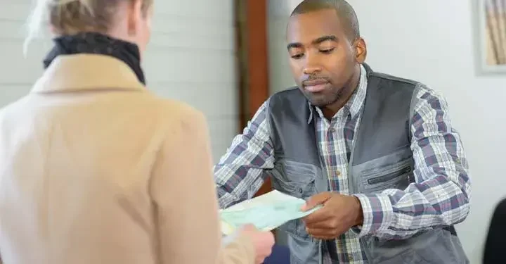 Woman handing a man paperwork