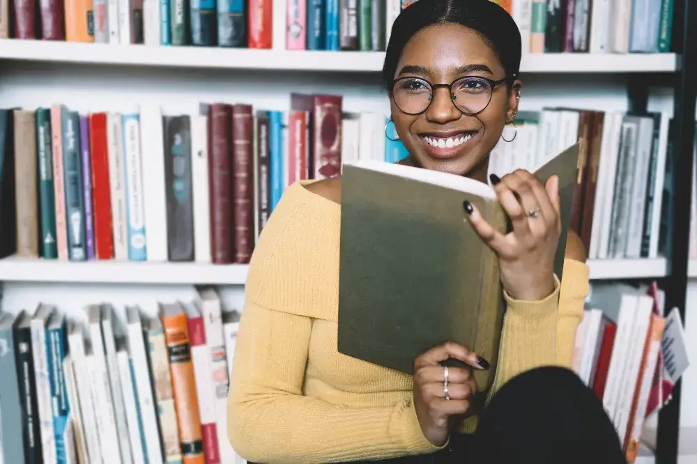 A woman looks over a new novel in her bookstore, which is not in the same state where she lives. A few states--Delaware, Nevada, and Wyoming--are commonly recommended for non-resident LLC owners