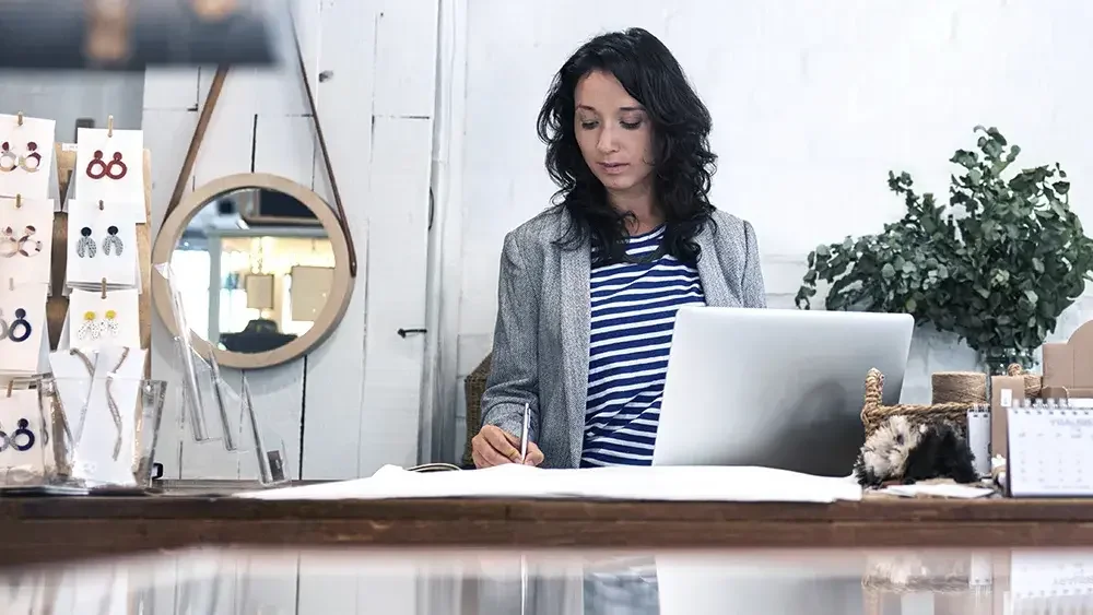 woman taking notes in her office 