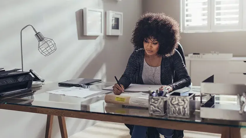 woman sitting at her desk doing her accounting