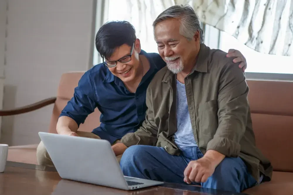 A son helps his father set up a healthcare proxy, also known as a health care power of attorney: online.