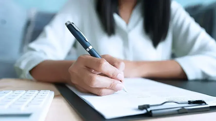 woman-filling-out-forms-on-clipboard