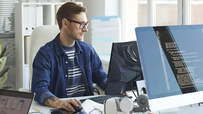 man building an app at an computer terminal 