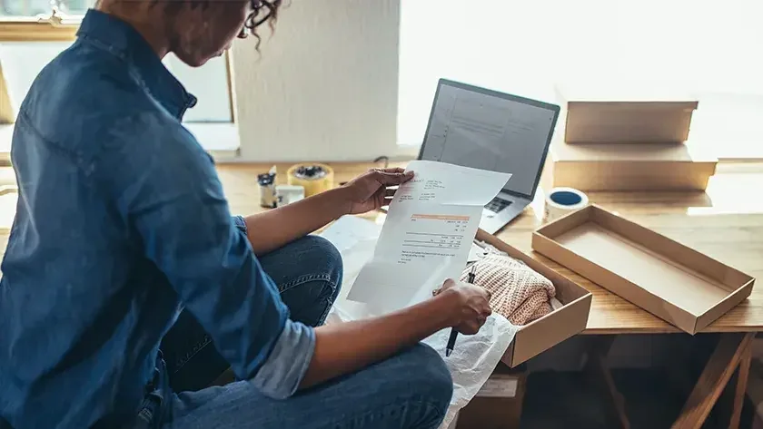 woman looking through her paperwork 