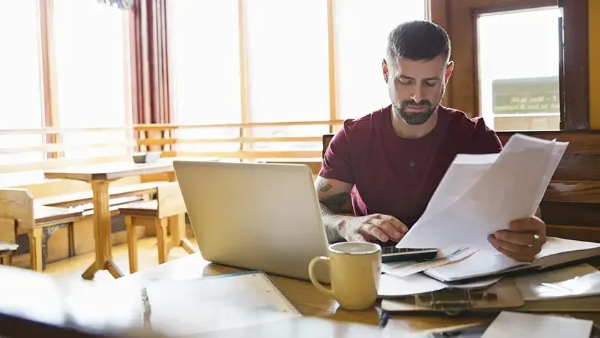 restaurant worker going thru paperwork 