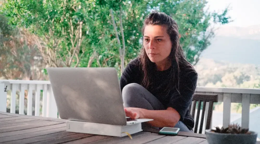 A small business owner in Utah works on her laptop computer while seated on her deck. While Utah doesn't have a general business license requirement, many cities and counties within the state set their own business licensing rules. 