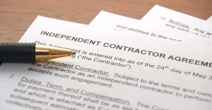 Pen sitting on independent contractor agreement