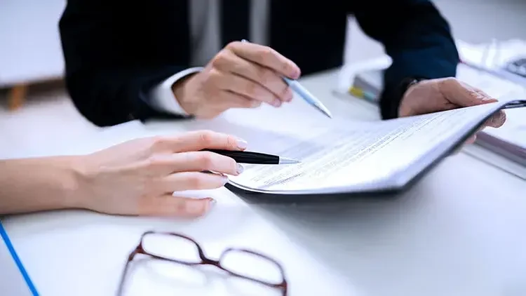 Woman and man signing documents