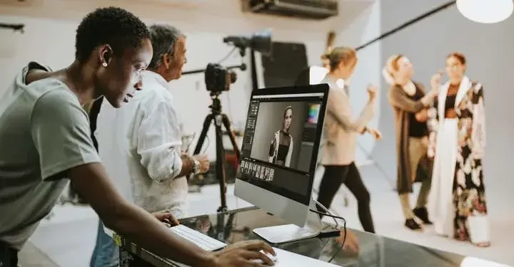 Woman looking at modeling photos on a computer at a photoshoot