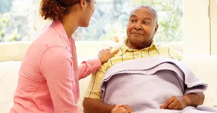 Woman with her arm on her father's shoulder