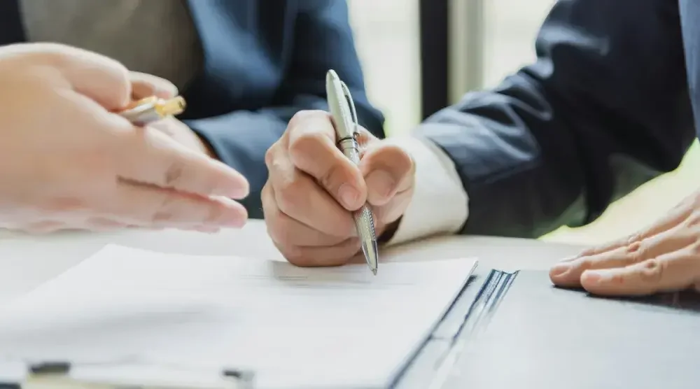 A Connecticut business owner and business advisors review information in their annual report.