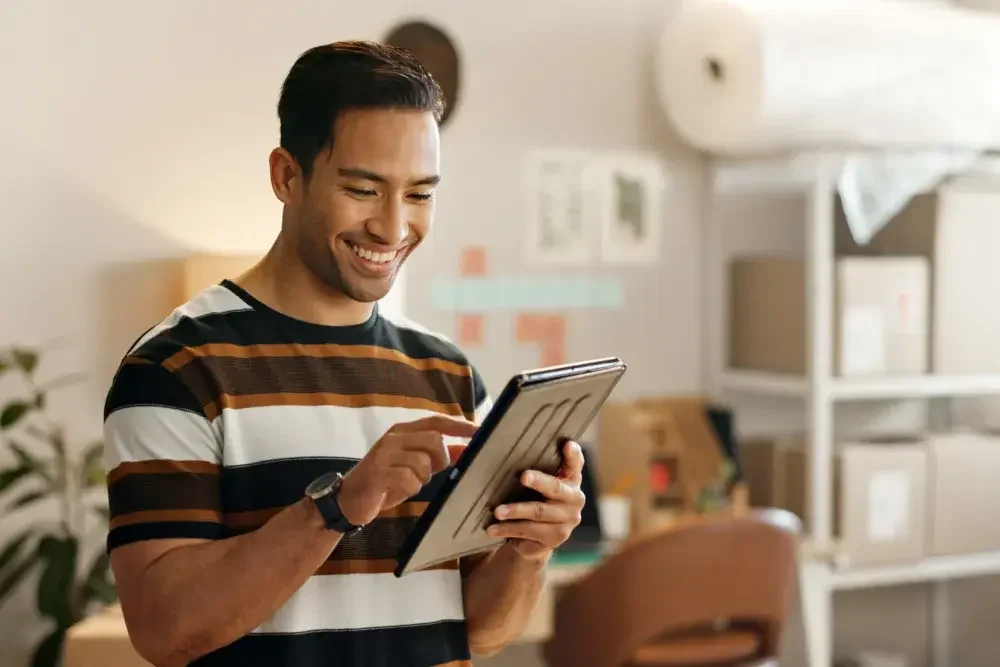 A small business owner smiles as he realizes he'll be getting a tax refund.