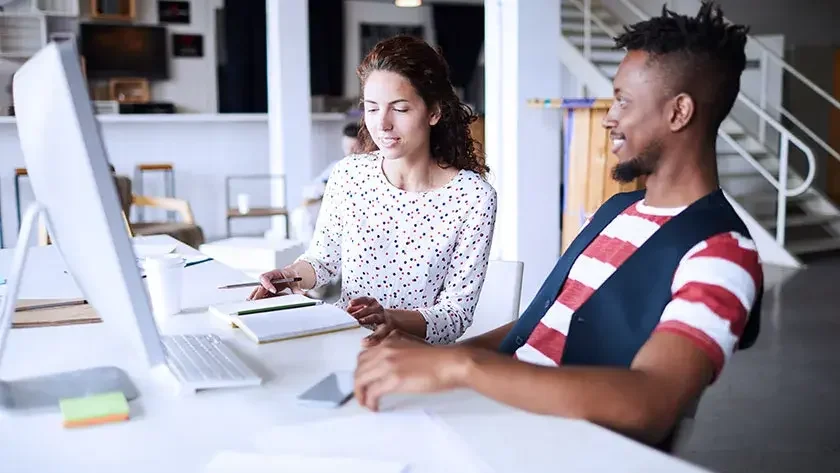 woman-man-at-desk-talking-business